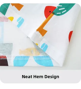 Detail of white cotton kids T-shirt hem showing neat stitching and colorful fish prints