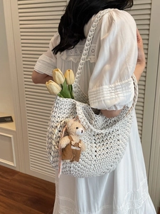 Minimalist woven shoulder bag in off-white cotton rope with a cute bear plush pendant