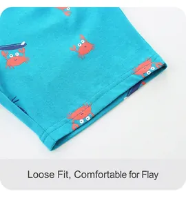 Detail of blue cotton knit shorts featuring red crab prints and double-needle stitching