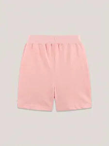 Pink rib-knit cotton sports shorts for girls with an elastic waistband shown in flat lay