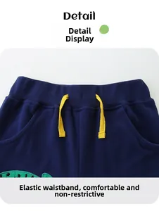 Detail of navy knit shorts featuring an elastic waistband with a yellow drawstring