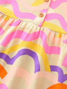 Girl's knit cotton dress with colorful wave patterns and rustic wooden buttons