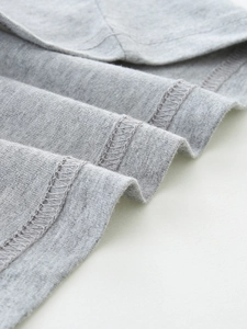 Close-up of gray knit cotton boy's t-shirt showing high-quality hem stitching details