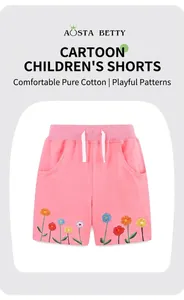 Detail view of pink cotton girls' shorts featuring vibrant floral embroidery and drawstring