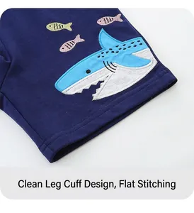 Detail view of navy knit boys shorts featuring high-quality shark and fish embroidery