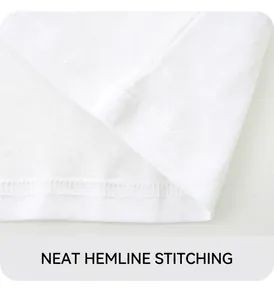 Close-up of white cotton T-shirt hem featuring neat double-needle stitching detail