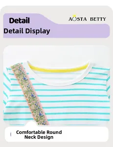 Detail of girls' striped cotton dress showing floral embroidery and round neckline