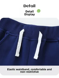 Detail of navy blue kids sports shorts featuring elastic waistband and white drawstring
