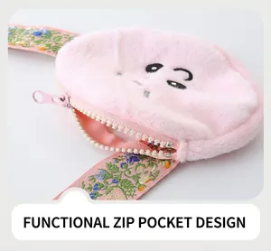 Detail of pink plush pocket with large plastic zipper and floral embroidery accents