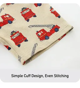 Detailed view of kids cotton shorts cuff with red cartoon firetruck print and fine stitching