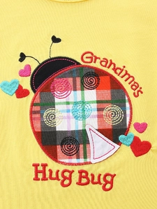 Yellow girls' summer set featuring embroidered ladybug pattern and Grandma's Hug Bug text