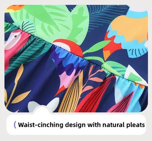 Detail of waist design with tropical bird print and natural gathered pleats on girl dress