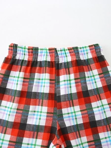 Close-up of classic red and black plaid kids shorts with elastic waistband and twill fabric