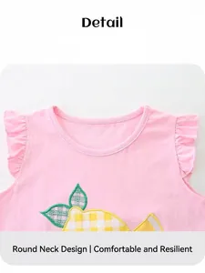 Detail of girls pink sleeveless cotton top with ruffled shoulders and lemon embroidery