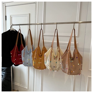 Detail showing colorful sequin embellishments on hollow knit tote bags in various colors