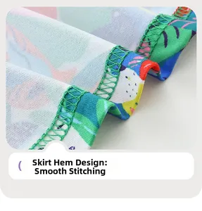 Detailed view of tropical print girl dress hem with neat green overlock stitching