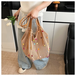 Detail of bohemian knit tote bag with colorful sequins and brown leather straps