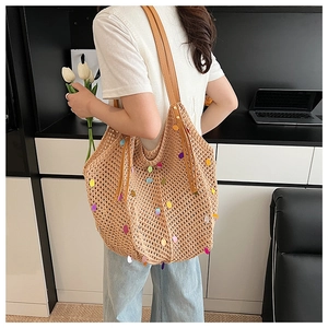 Detail of colorful sequins and woven texture on a large capacity tote shoulder bag