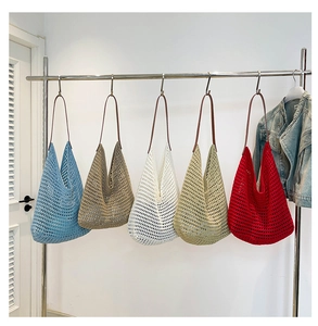 Detail of colorful hollow knit tote bags with leather handles for summer beach use