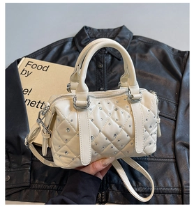 Detail of white quilted Boston bag with sparkling rhinestones and adjustable strap