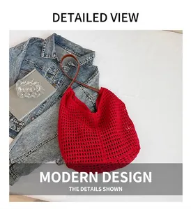 Detail of red hollow woven tote bag featuring brown leather straps on denim background