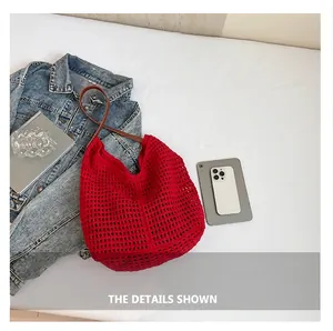 Detail of red hollow knit tote bag featuring soft mesh texture and brown slim shoulder straps