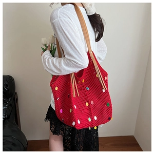 Detailed close-up of a red crochet tote bag featuring vibrant multicolor teardrop sequins
