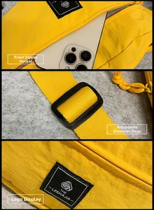 Detail of yellow nylon bag showing front zipper pocket, adjustable strap, and logo label