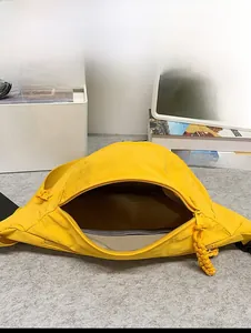 Detail view showing internal capacity of the yellow sports waist bag with zipper open