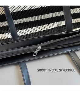 Detail shot of the smooth silver metal zipper pull on a striped woven beach tote bag