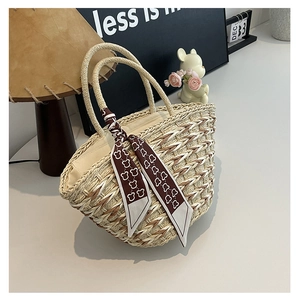 Detailed texture of beige straw tote bag featuring a brown teddy bear pattern silk scarf