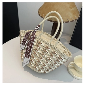 Detail of woven straw handbag with brown striped pattern and floral bear silk scarf handle