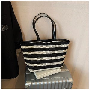 Détail de la texture tissée et des poignées du sac fourre-tout à rayures