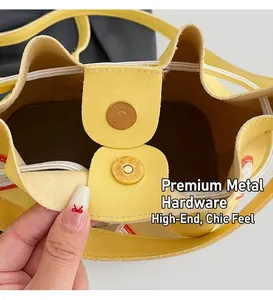 Detail of golden magnetic hardware closure on yellow lychee texture faux leather bag