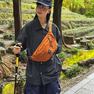 Outdoor close-up of a brown nylon chest bag for women in a mountain hiking scenery