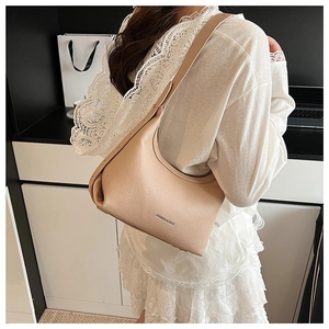 Detailed close-up of beige lychee grain leather hobo bag with Fashion & Bags logo