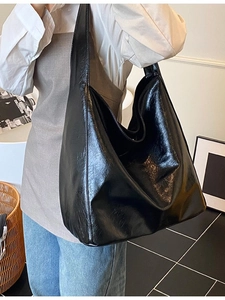 Large black glossy leather hobo bag for women with minimalist shoulder strap design