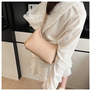 Close-up of beige lychee grain leather crossbody bag with minimalist MISSGOUBAGS logo