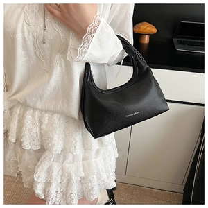 Close-up of black lychee grain leather underarm bag with silver Fashion & Bags text