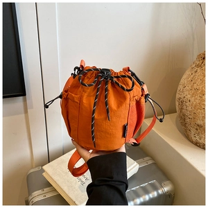 Detail of bright orange waterproof nylon bucket bag with Soul River brand label