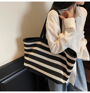 Detailed view of the large capacity tote bag with stylish black and white woven stripes