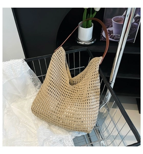 Detail of khaki crochet woven tote bag with brown leather strap in minimalist style
