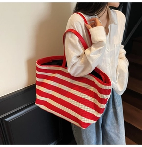 Detail of red and white striped knit tote bag showing breathable mesh texture