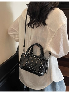 Quilted black Boston bag with silver studs and adjustable shoulder strap for women