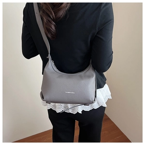 Detail of dark grey lychee grain leather hobo bag featuring FASHION & BAGS text