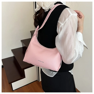 Detail of pink lychee textured leather bag showing silver Fashion & Bags lettering