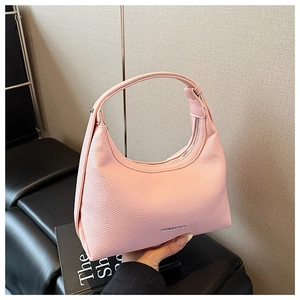 Detail view of pink pebbled leather hobo bag with silver Fashion & Bags logo lettering