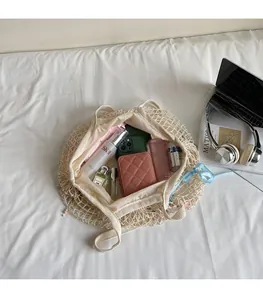Spacious interior of a cream woven mesh tote bag showing large storage capacity