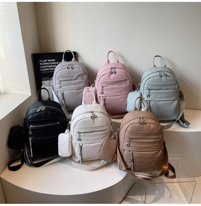 Detailed display of fashionable PU leather backpacks in various colors with textured straps