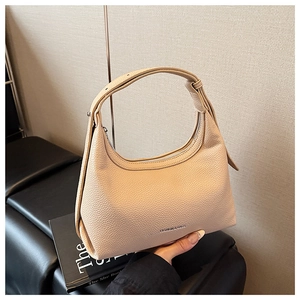Macro detail of creamy white lychee grain leather texture and metallic zipper closure
